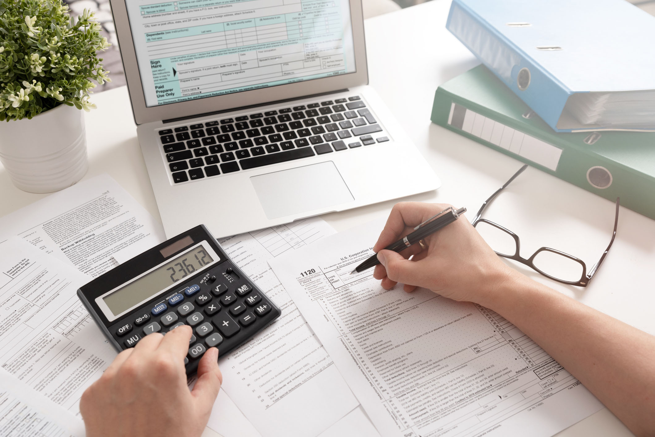 Tax documents and calculator on desk