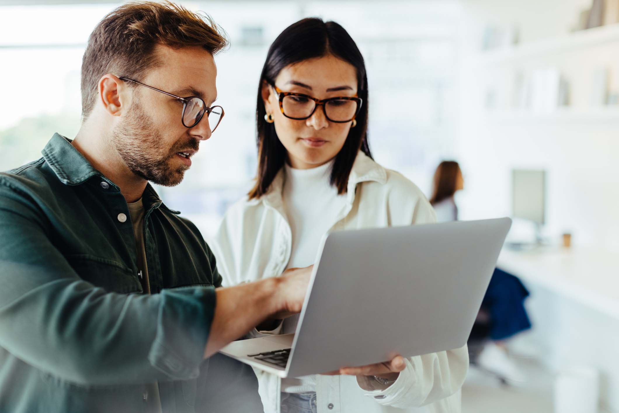 Two professionals reviewing tax information on laptop